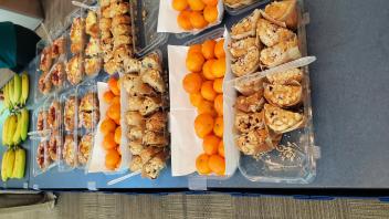 Breakfast at the showcase. Bananas, oranges, and pastries.