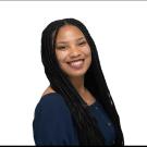 Alisha smiling with a white background